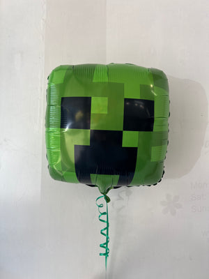 Minecraft Creeper foil balloon by Anagram, featuring a green Creeper character from the popular video game, against a colorful background.
